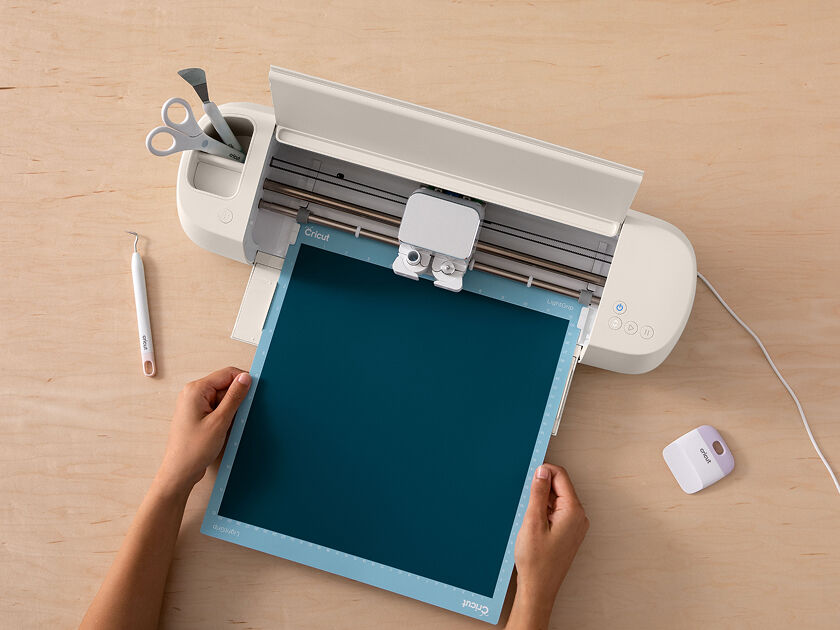 Cricut Explore 3 smart cutting machine cutting blue vinyl